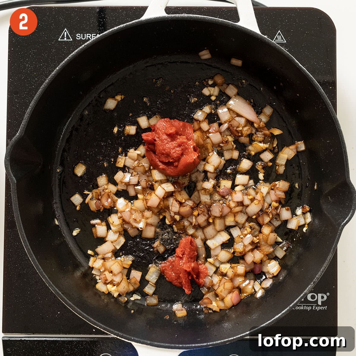 Caramelizing tomato paste in the saucepan with shallots.