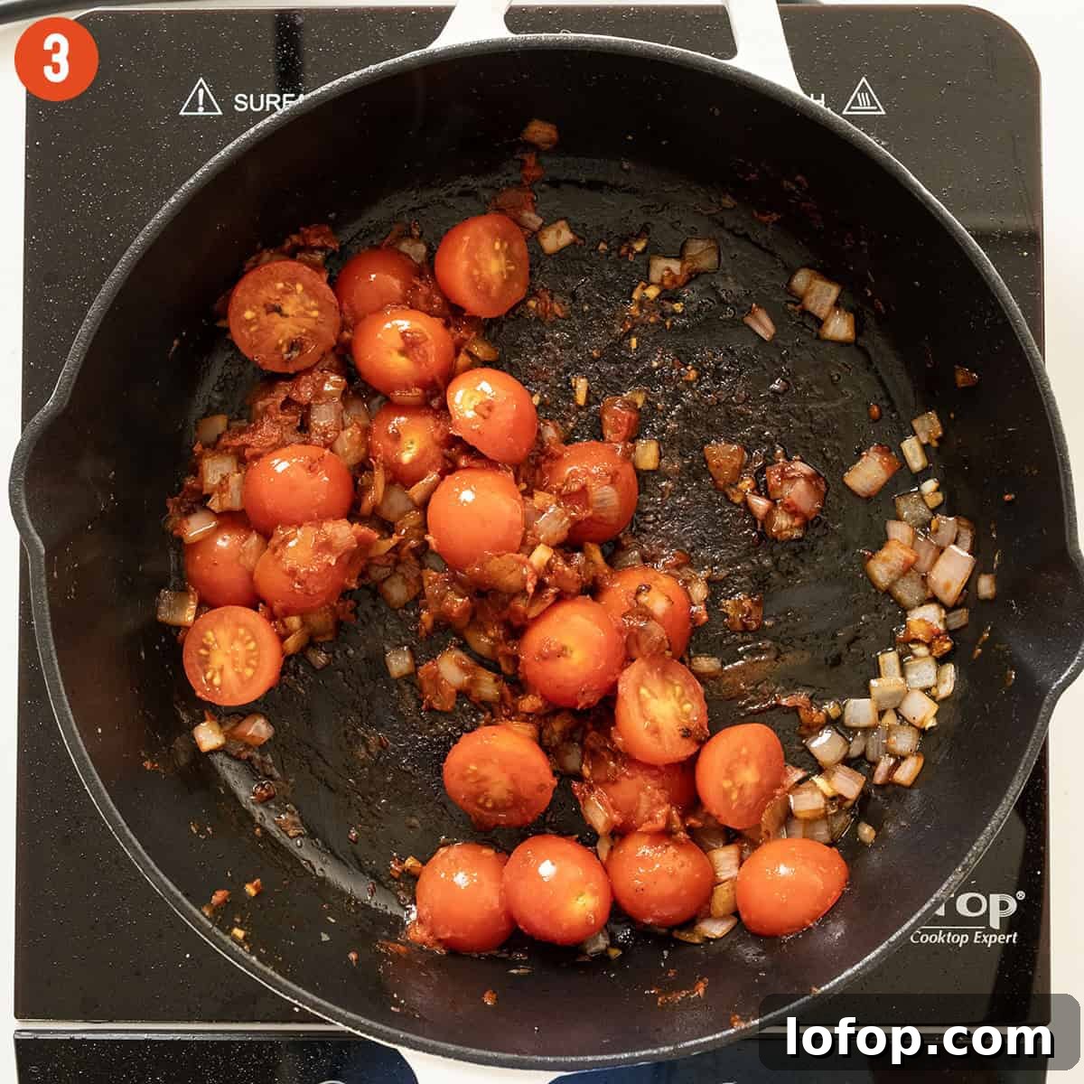 Sauteing cherry tomatoes in saucepan.