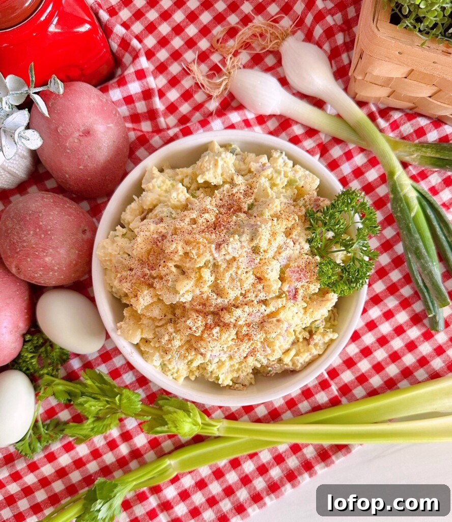Overhead photo of potato salad with ingredients surrounding it.