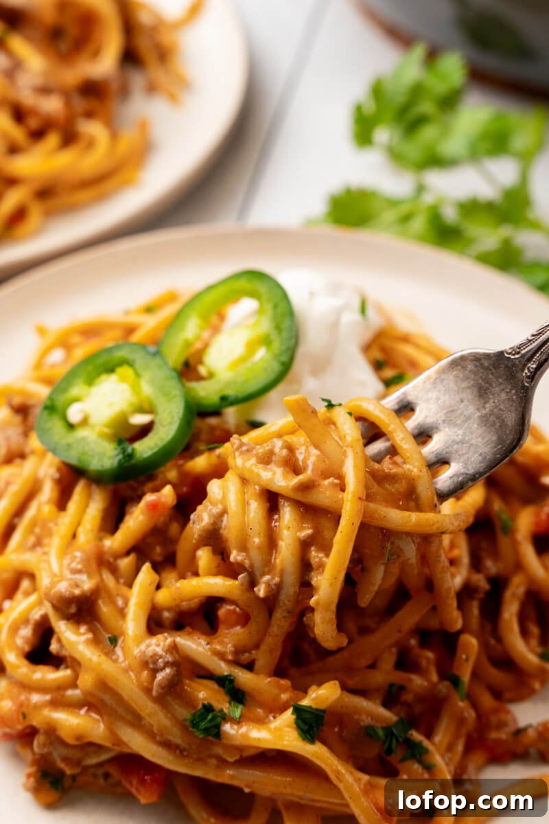 A fork takes a bite's worth out of the serving of food.