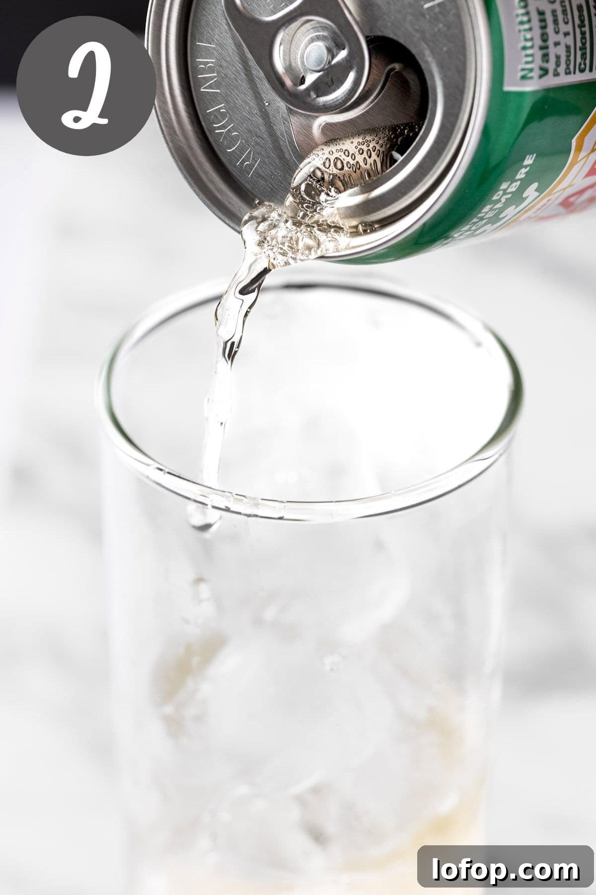 Ginger Ale Mojito Recipe: Refreshing Mint Cocktail Guide 5 Pouring the ginger ale into the mojito glass.