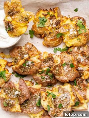 smashed potatoes in parchment paper with side of sour cream.