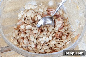 pumpkin seeds mixed in bowl with bacon.