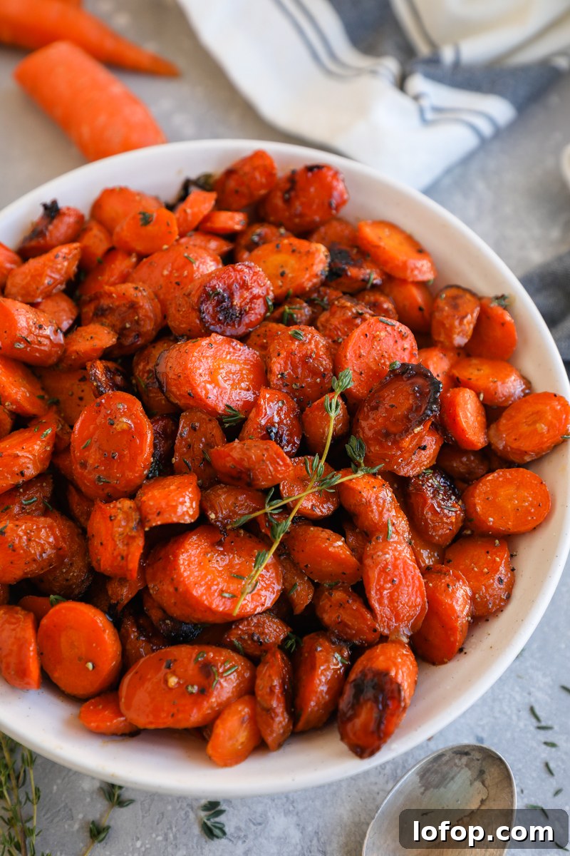 Carrot slices tossed in a brown butter maple sauce then roasted until crispy and sprinkled with salt, pepper and fresh thyme