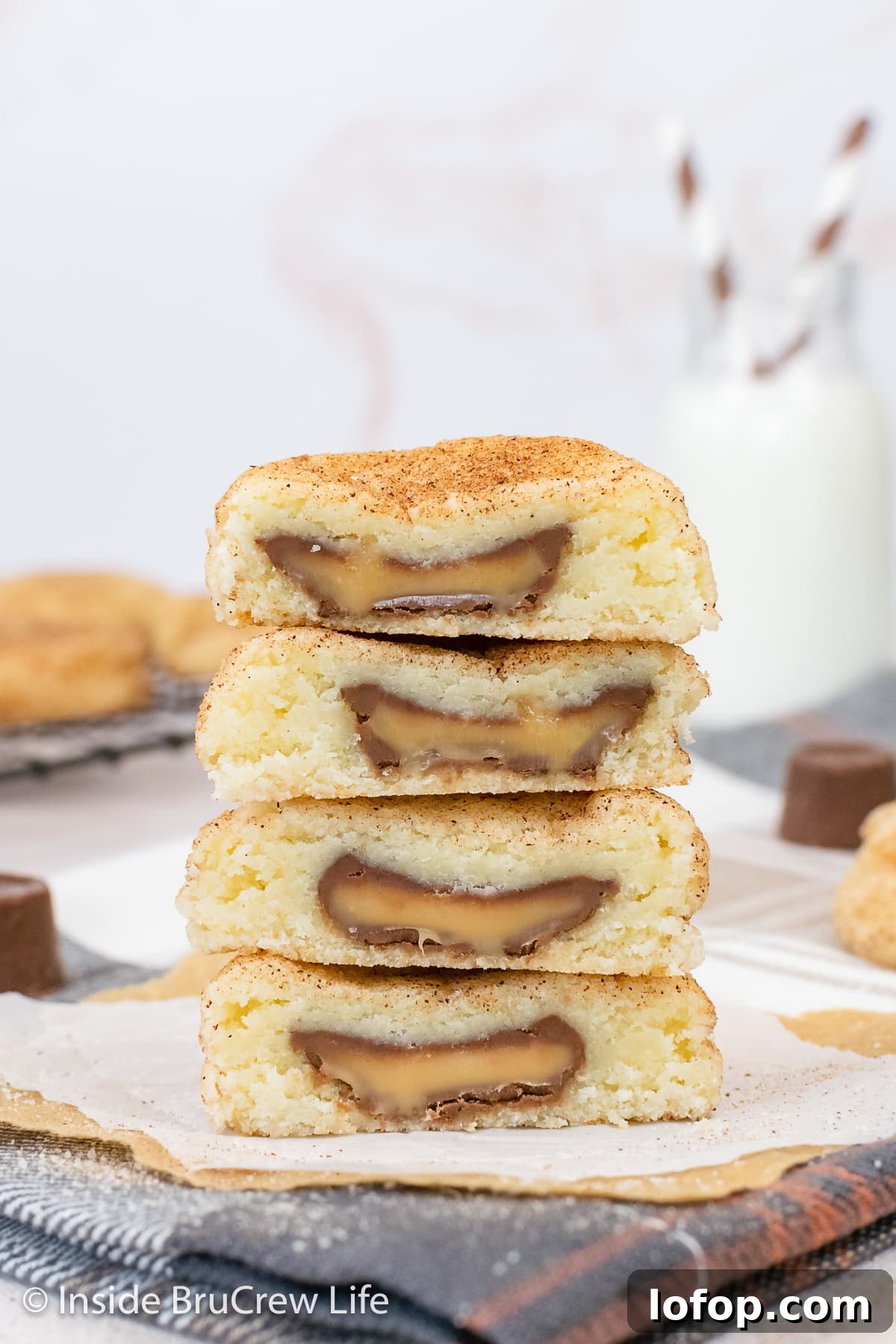 Four cookies cut in half and stacked showing a gooey caramel center.
