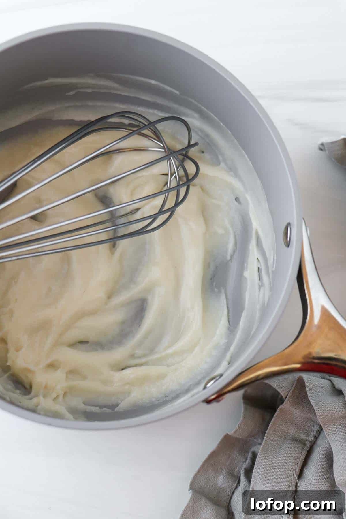 Tangzhong in a saucepan with a whisk.