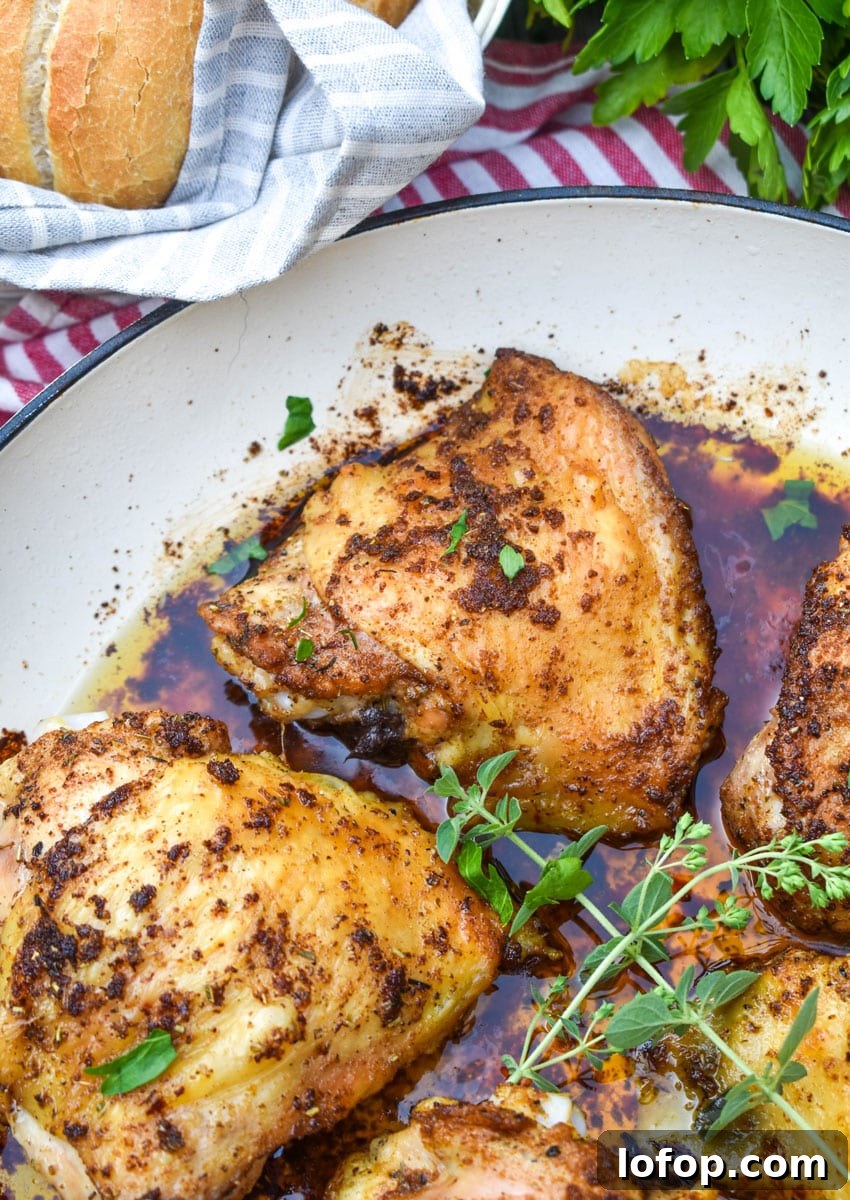 crispy italian chicken thighs in a large white cast iron skillet