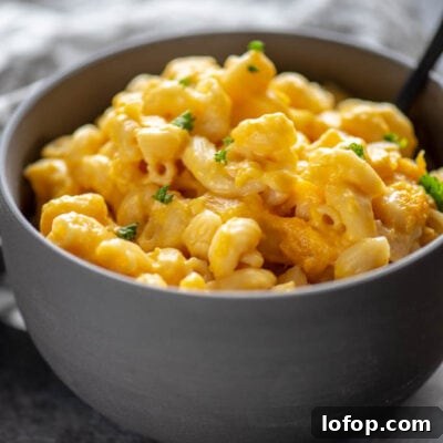Mac and cheese in a gray bowl topped with parsley