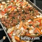A sheet pan of sausage and mixed vegetables.