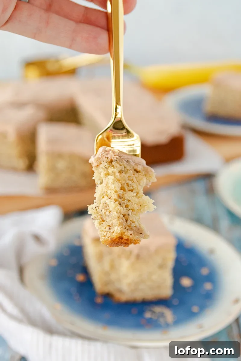 Moist Banana Snack Cake with Creamy Nutella Frosting 7 bite of banana cake on a fork close to the camera