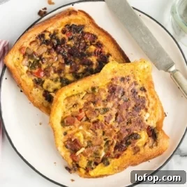 Close-up of melted cheese pulling apart from an omelet-filled grilled sandwich.