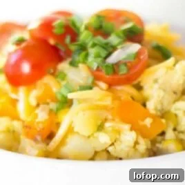 close up shot of Campfire Scrambled Eggs topped with herbs