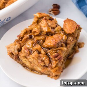 Slice of Pumpkin Bread Pudding drizzled with cinnamon syrup, on a white plate.