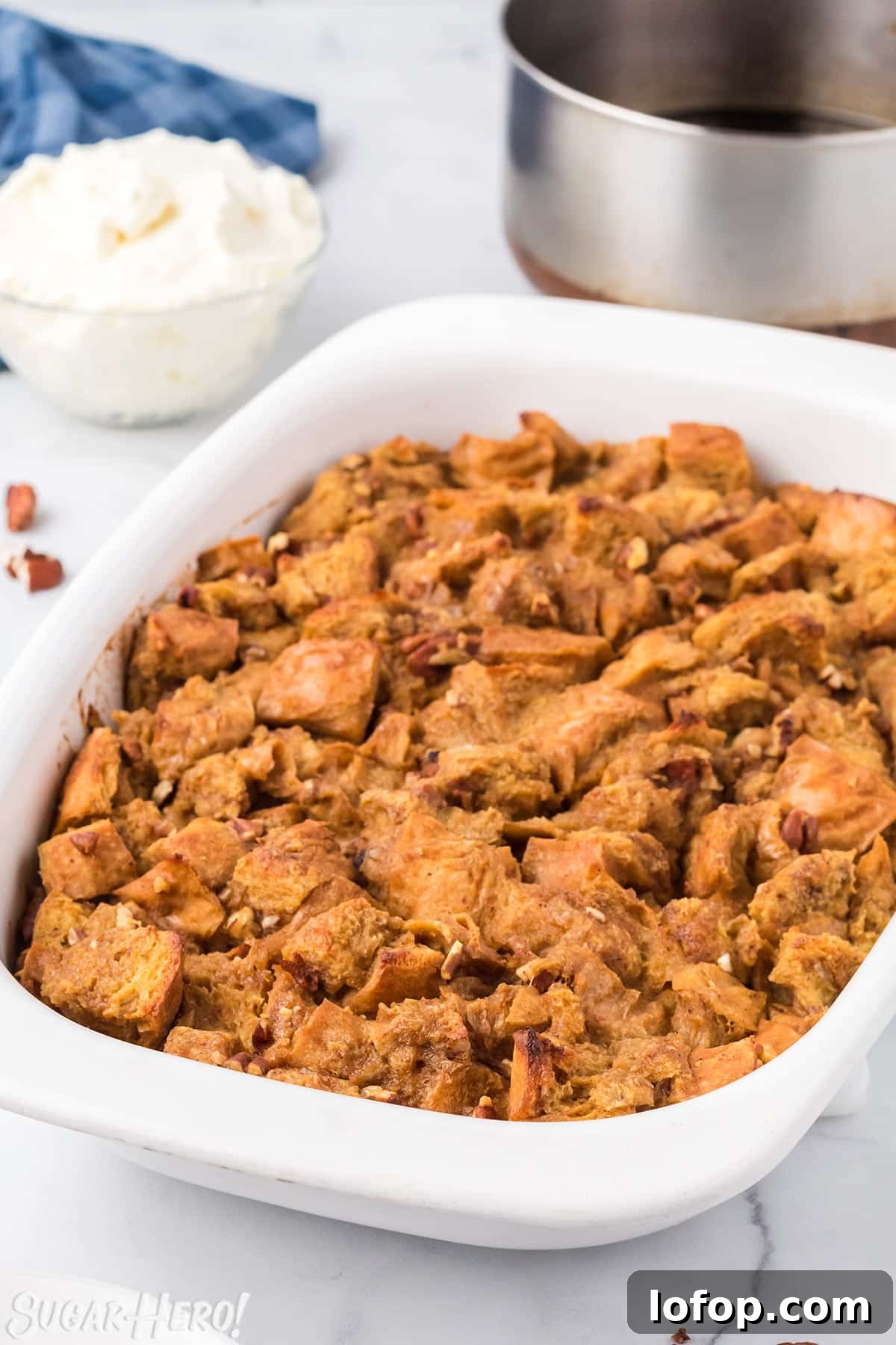 Creamy Pumpkin Bread Pudding with Spiced Caramel Sauce 3 Pumpkin Bread Pudding baked in a large casserole dish, on a white marble surface.