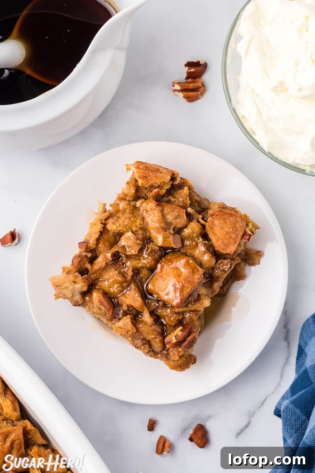 Creamy Pumpkin Bread Pudding with Spiced Caramel Sauce 5 Slice of Pumpkin Bread Pudding on a white plate, drizzled with cinnamon syrup.