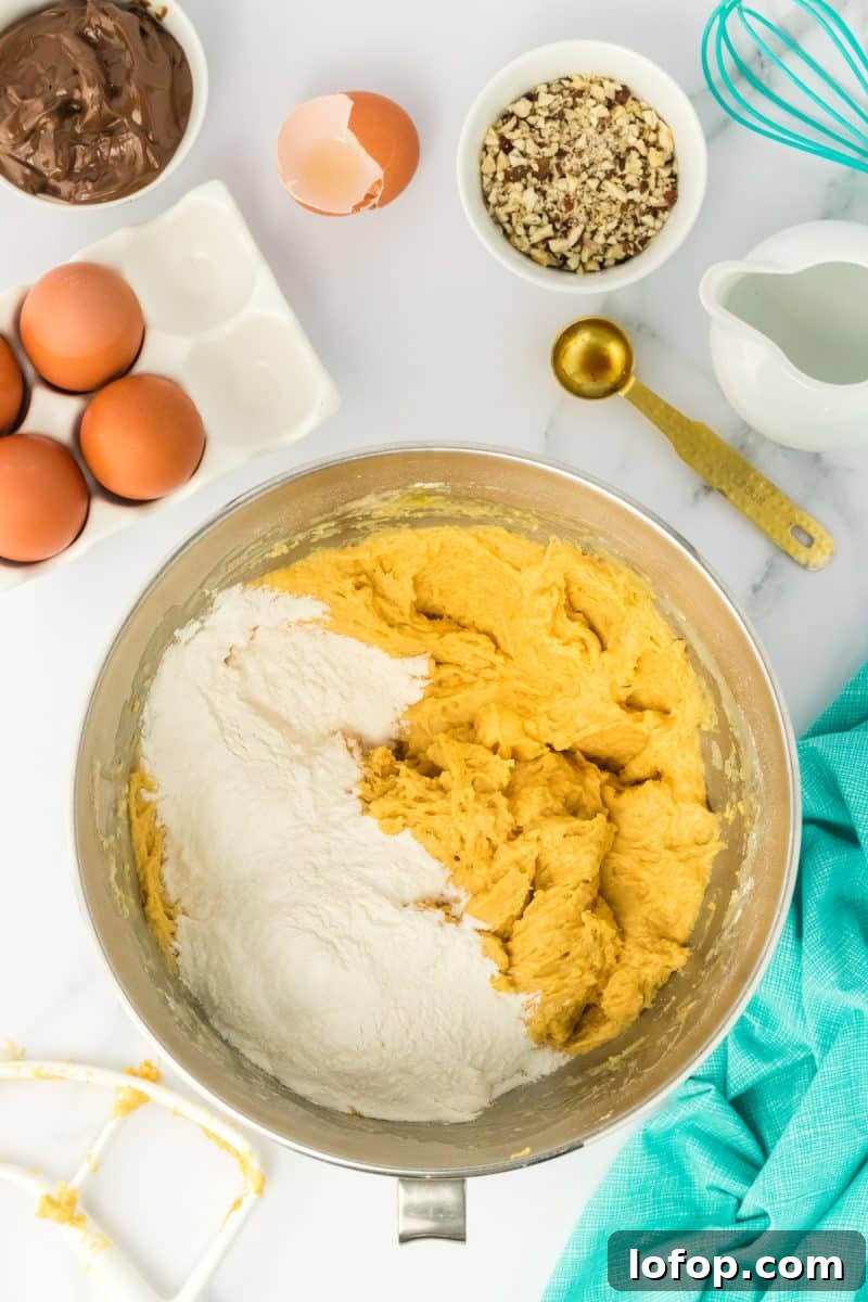 An electric stand mixing bowl filled with bread dough and flour to get the right consistency. Hostess At Heart