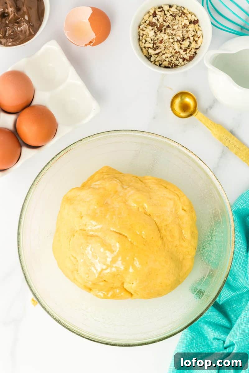 A ball of pumpkin hazelnut bobka bread dough in a mixing bowl - Hostess At Heart