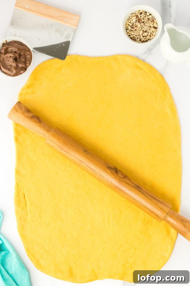 Top down view of rolled out bread dough in the shape of a rectangle. Hostess At Heart