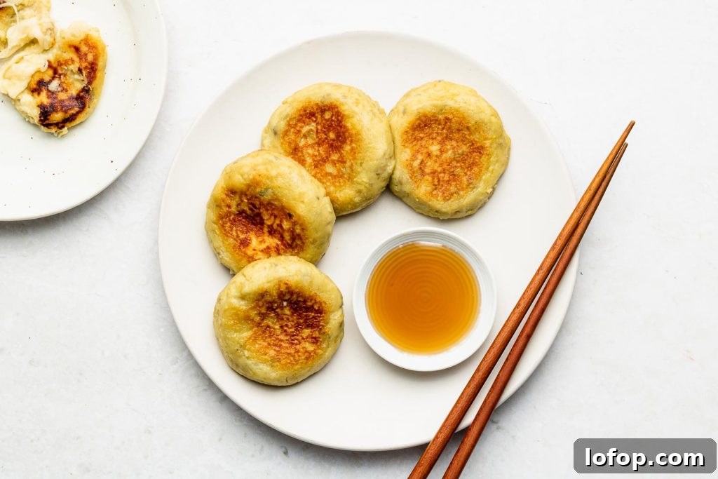 japanese sweet potato stuffed with cheese on a white plate with honey and maple syrup