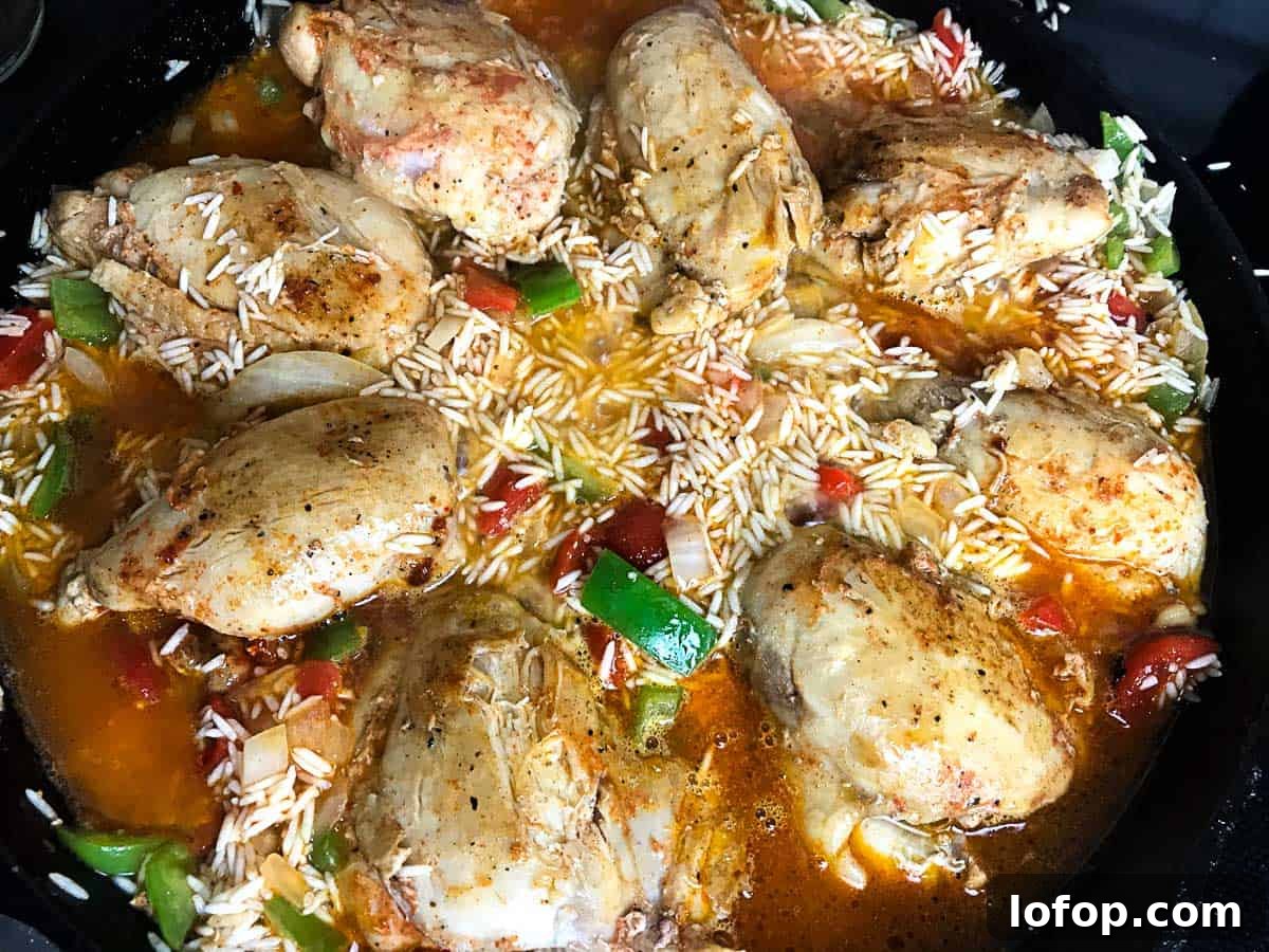 Chicken thighs, rice and veggies in skillet