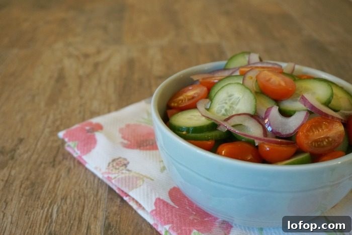 This recipe is so tasty on a hot summer day and travels well for potluck suppers. You simply must try this quick and easy cucumber, tomato and onion salad recipe.