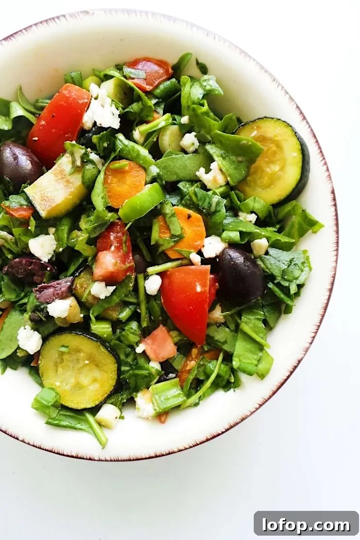 A refreshing and satisfying healthy and easy summer salad with tomatoes, feta cheese, greens, grilled vegetables