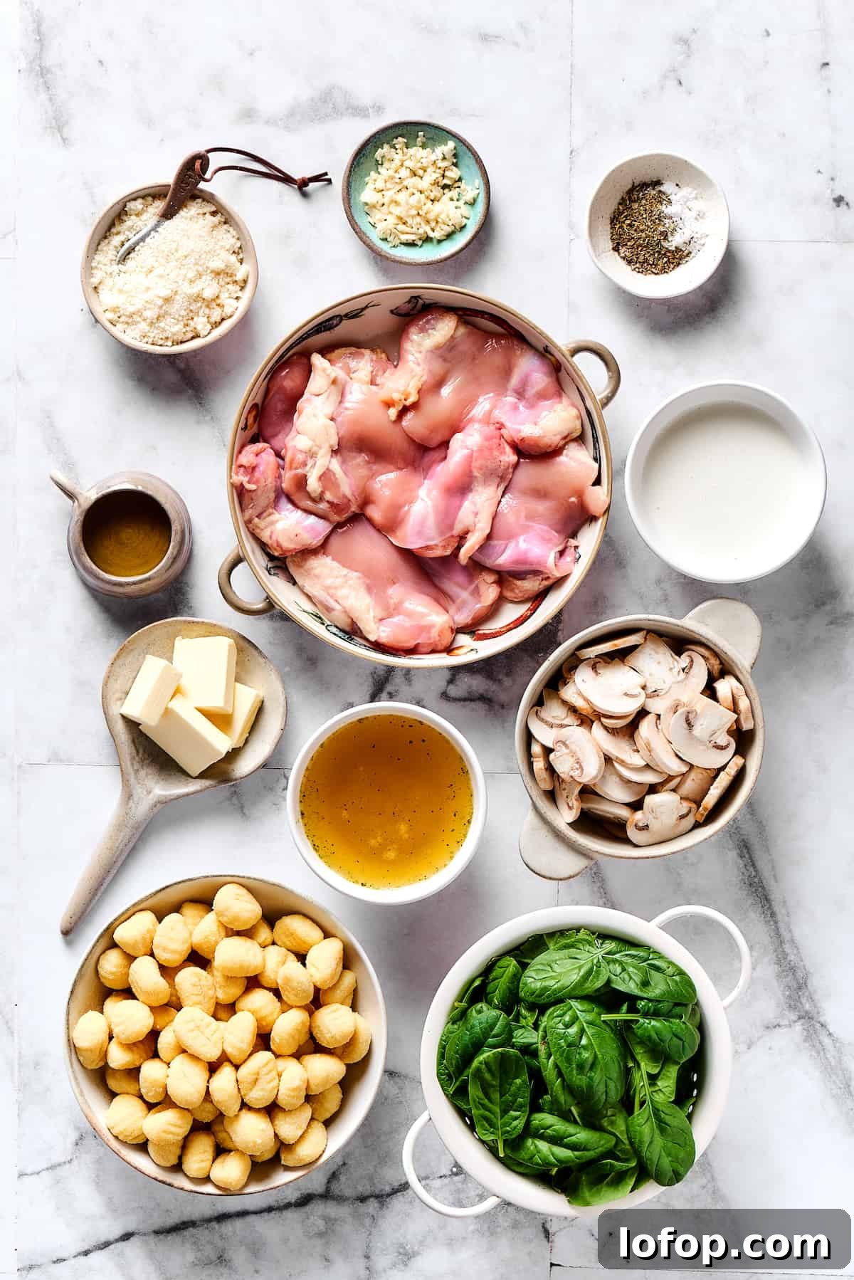 Ingredients for creamy chicken and gnocchi. Chicken gnocchi ingredients measured and arranged on a table.