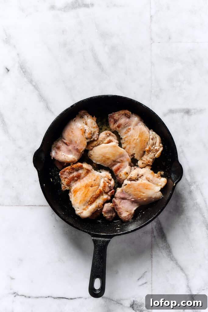 Creamy Chicken and Gnocchi Skillet with Garlic Parmesan Sauce 2 Chicken thighs browning in a skillet.