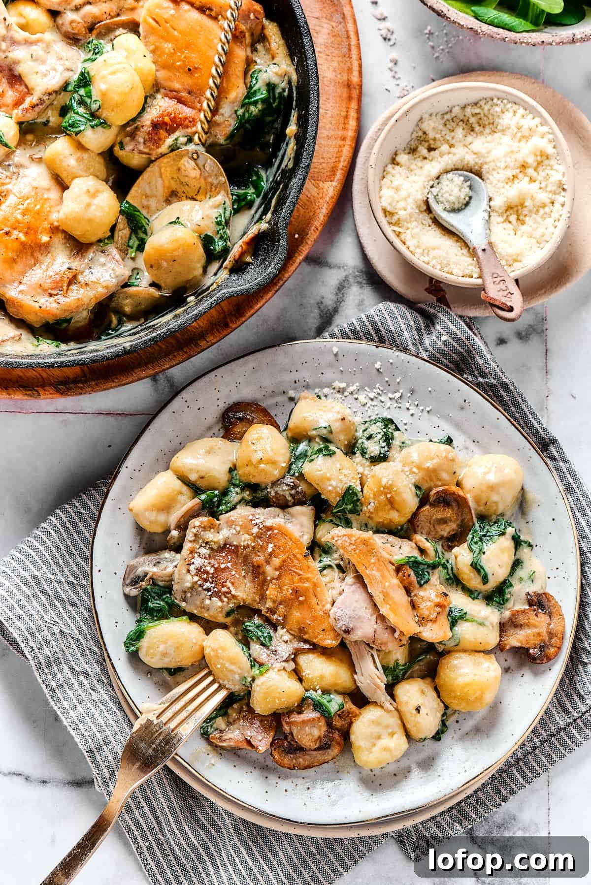 Creamy chicken and gnocchi served on a plate. Overhead shot of a chicken skillet dish served onto a dinner plate.