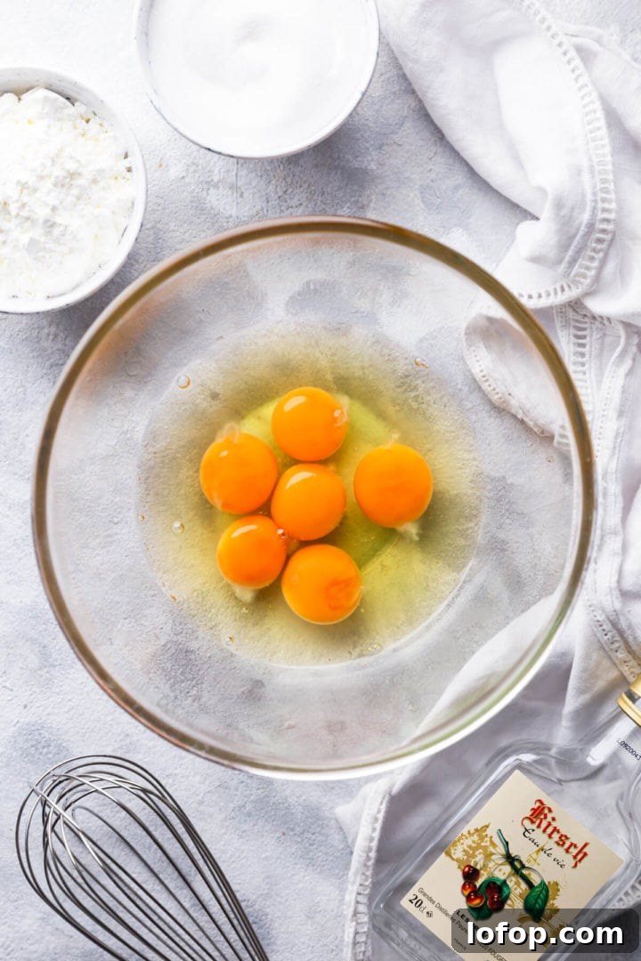 Classic French Fraisier Strawberry Cake Recipe 9 top view of glass bowl with eggs and egg yolks