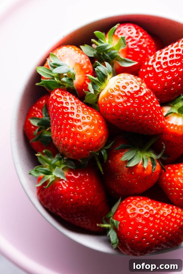 Classic French Fraisier Strawberry Cake Recipe 6 top view super close up of a bowl with fresh strawberries