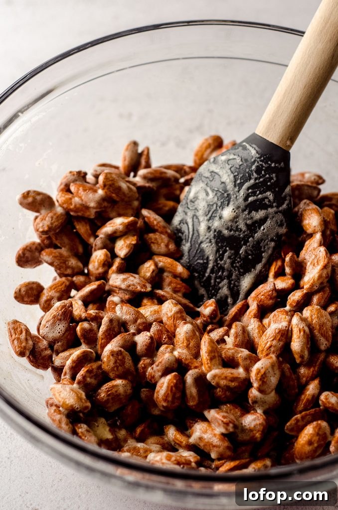 Cinnamon Sugar Candied Almonds Recipe | Crunchy Roasted Almonds 7 almonds in a glass bowl coated with vanilla paste and frothed egg whites to make candied almonds