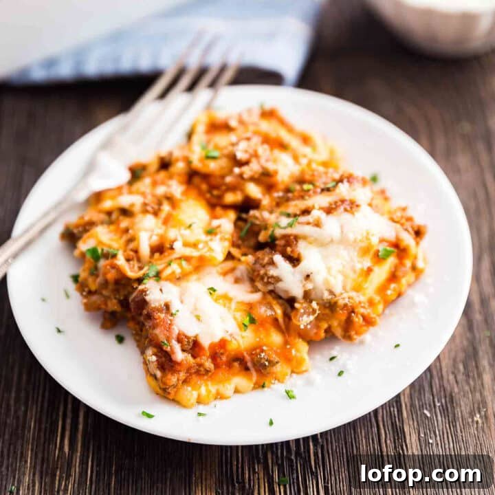 A plate of ravioli casserole with the pan behind it.