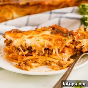 Ultimate Cheesy Baked Spaghetti Recipe for Comfort Dinner 16 A piece of baked spaghetti with a bite taken from it revealing the pasta inside.