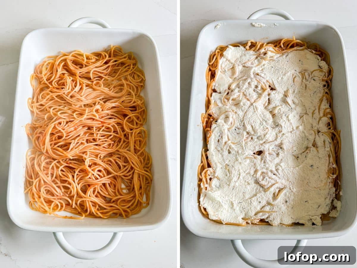 Ultimate Cheesy Baked Spaghetti Recipe for Comfort Dinner 7 Sauce and spaghetti in the baking pan and then the cheese mixture spread on top of it.