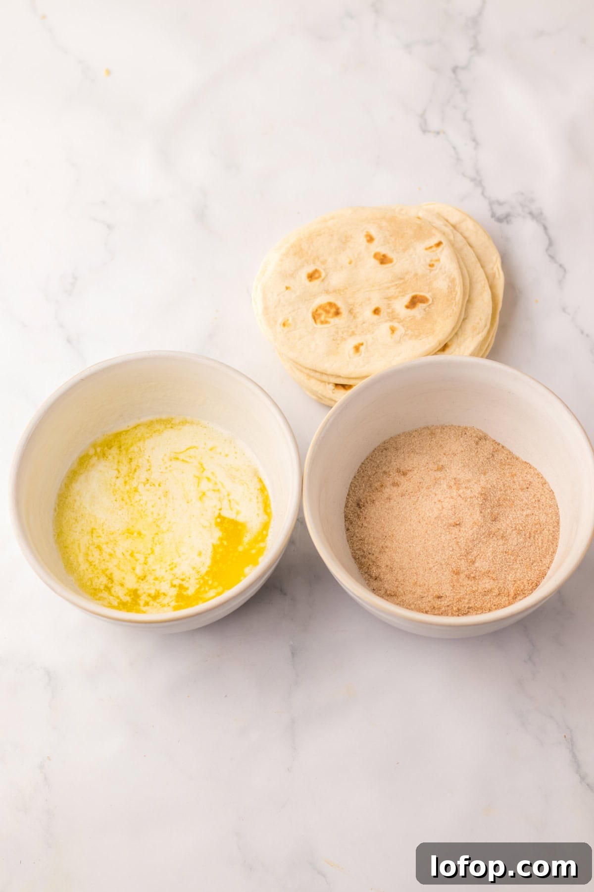 Bowls with melted butter and cinnamon sugar alongside tortillas