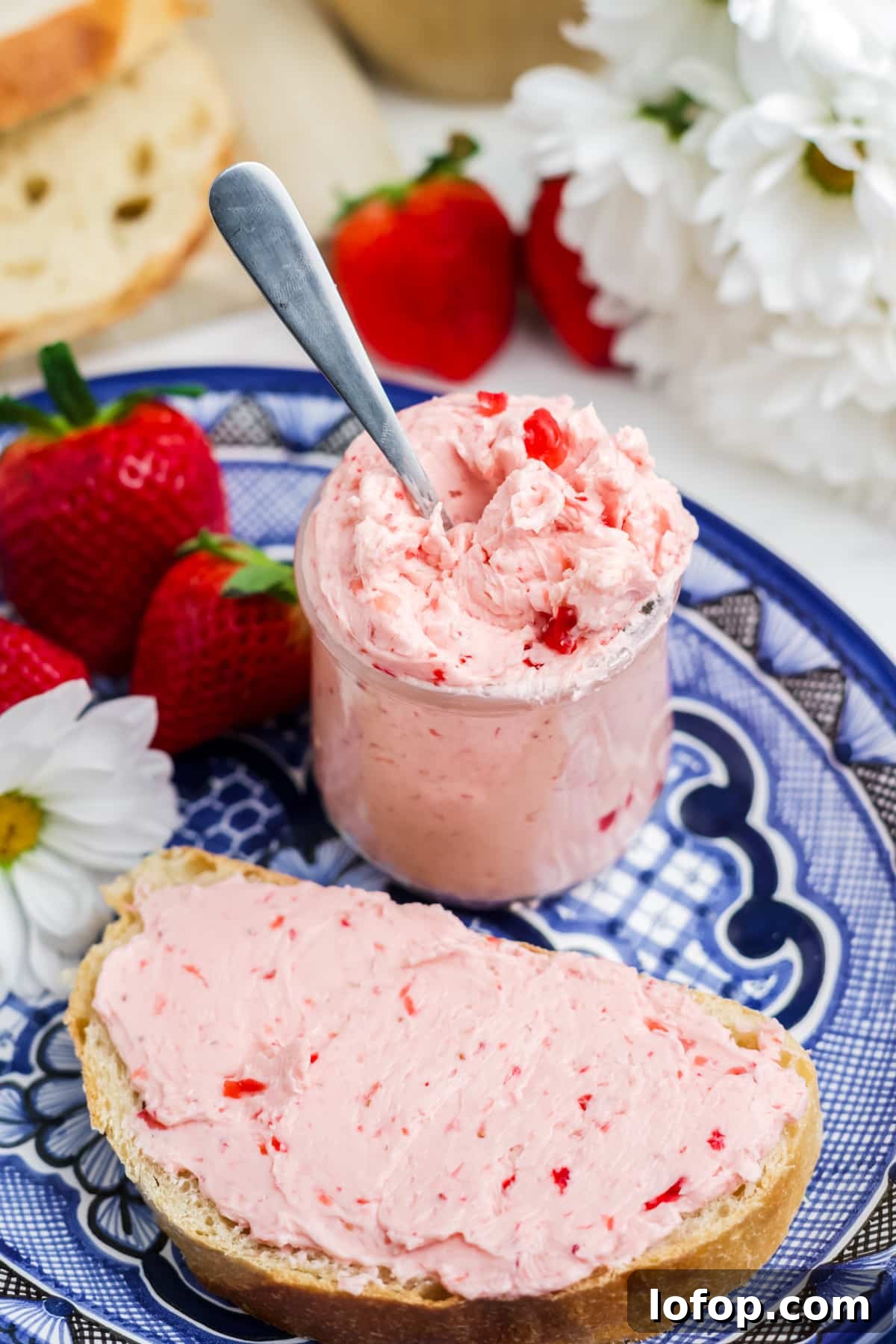Homemade Strawberry Butter Recipe: Sweet Spread for Toasts and Baked Goods 9 Strawberry butter in a jar and spread on bread.