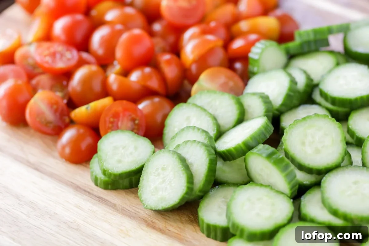 Fresh, vibrant Cucumber Tomato Salad is a simple salad perfect for summer and your bounteous harvest. It's a quick side for any meal! Diced veggies for Cucumber Tomato Salad.