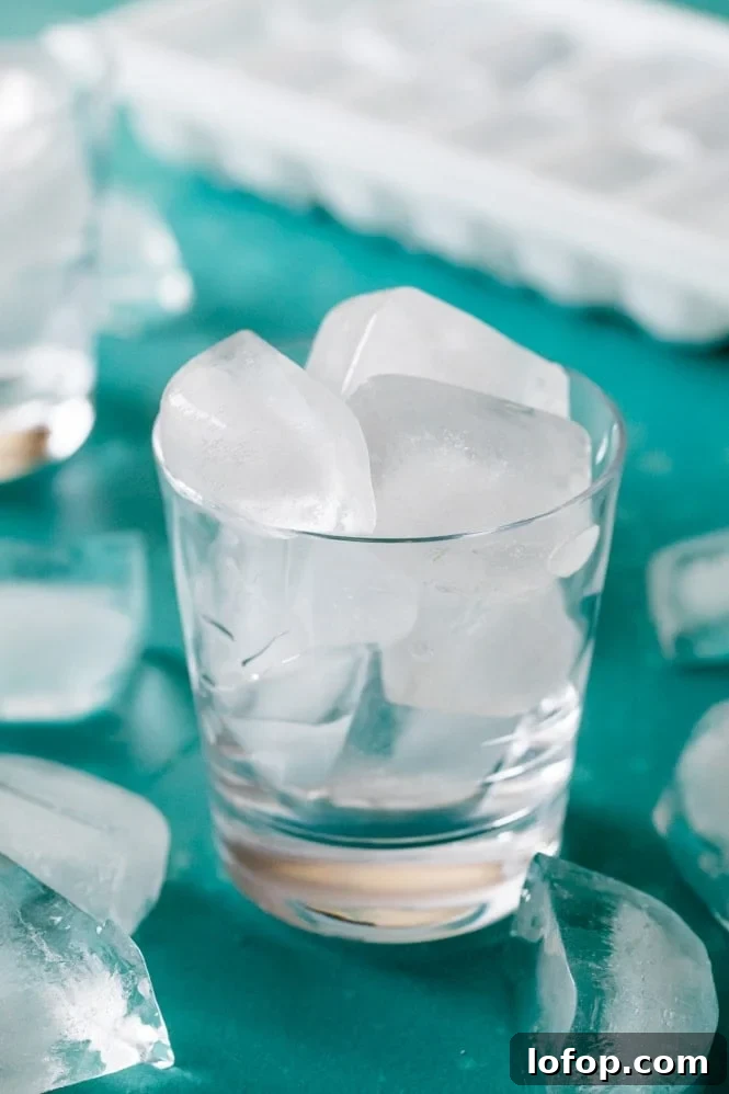 Ice cubes in a clear glass blue background