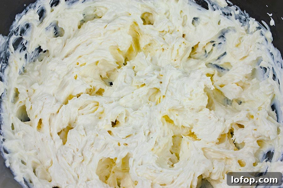 Creamy Buffalo Chicken Dip Recipe for Game Day and Parties 4 Buffalo Chicken Dip - cream cheese mixture in a mixing bowl