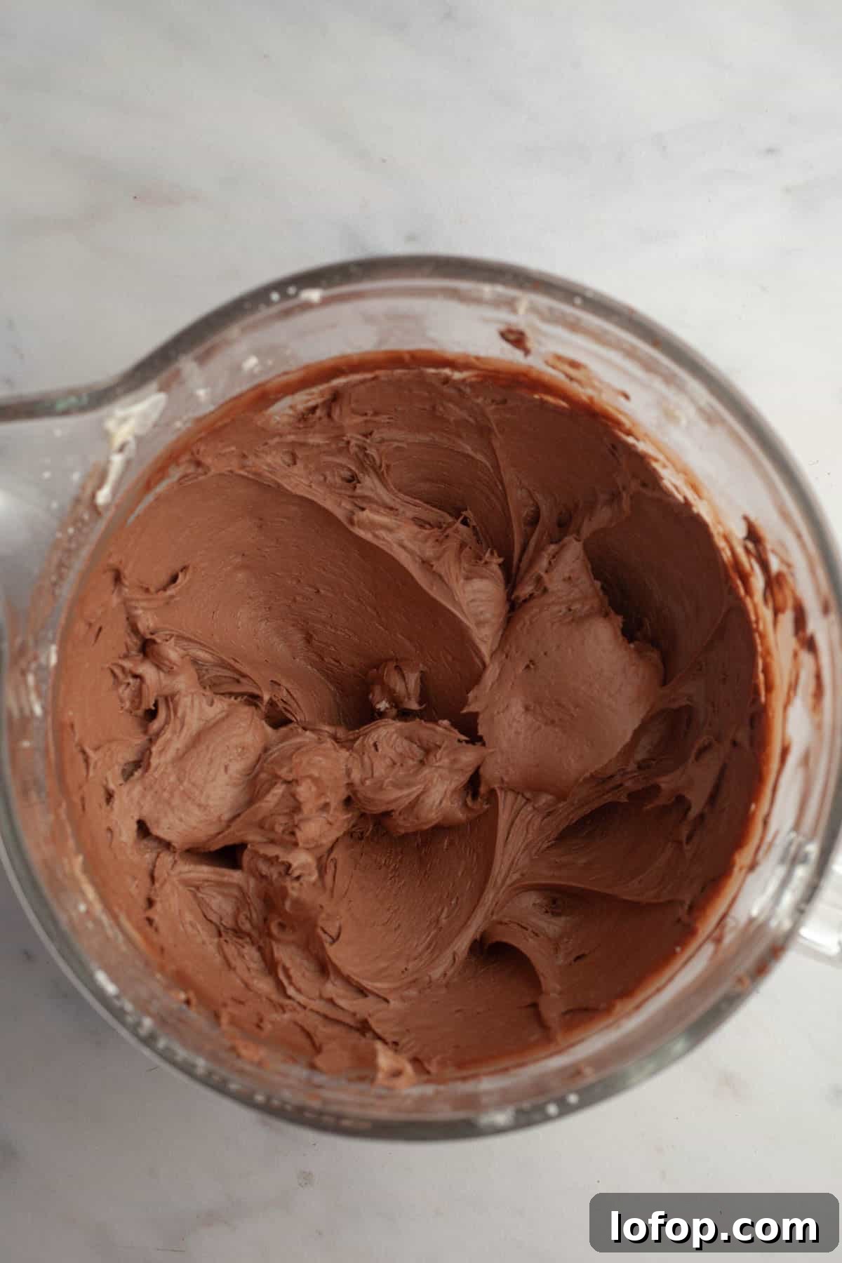 Decadent Chocolate Cupcakes with Cream Cheese Frosting 9 A large mixing bowl with chocolate frosting in it.