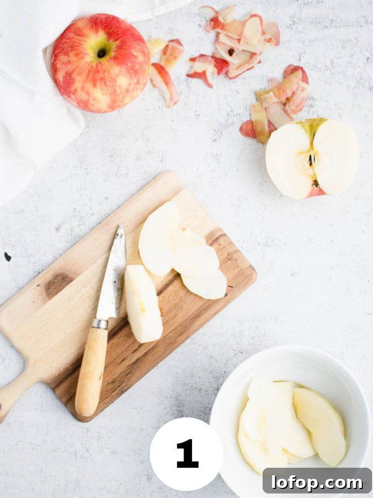 sliced apples on a cutting board with a small paring knife.