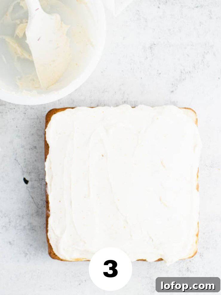 frosted square cake against a gray backdrop.