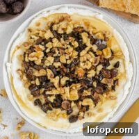Whipped Goat Cheese and Honey Dip — 5-Ingredient Recipe 13 Whipped goat cheese topped with honey, sliced dried figs and walnuts on a small round plate.