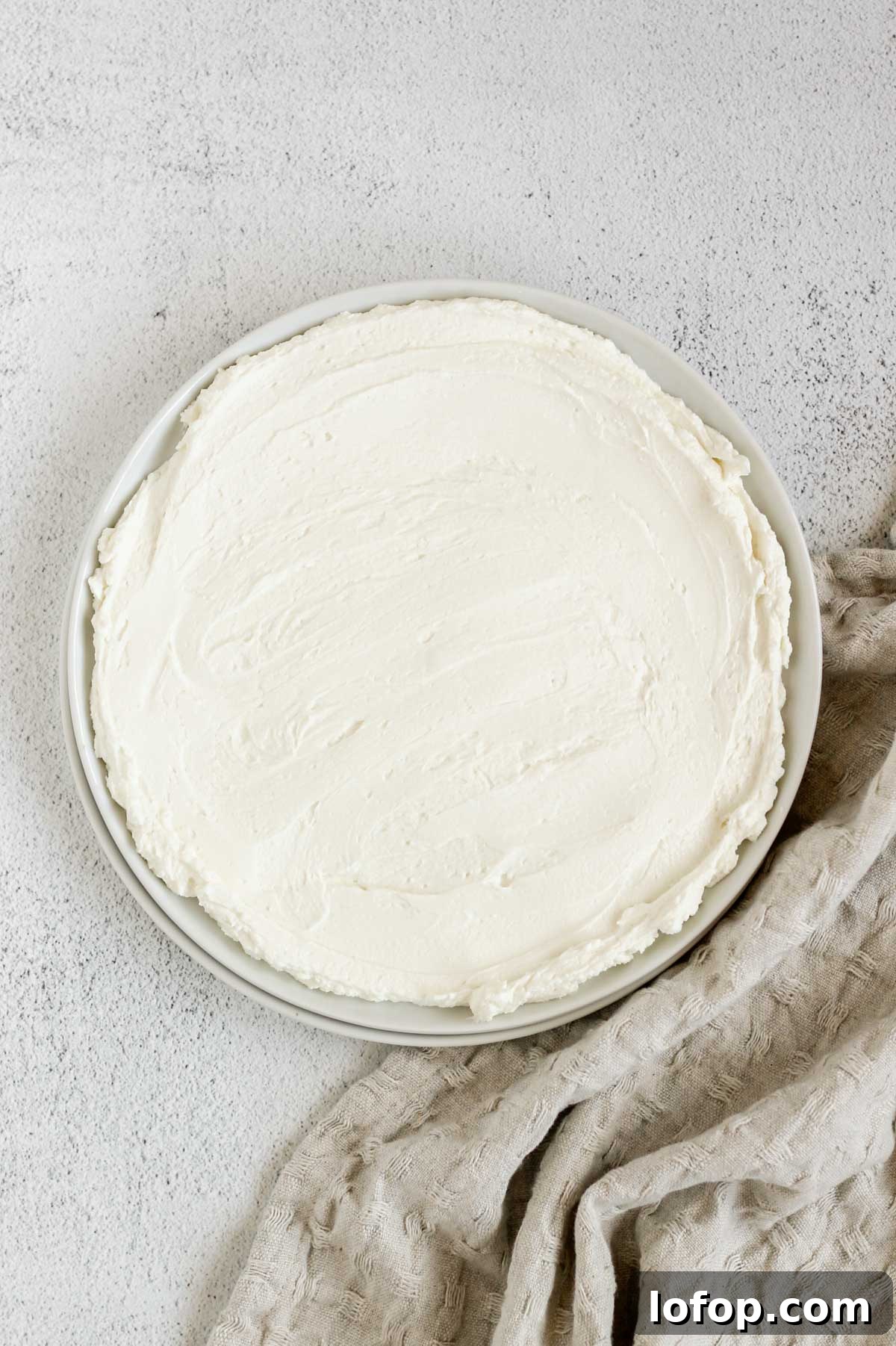 Whipped Goat Cheese and Honey Dip — 5-Ingredient Recipe 5 Whipped goat cheese spread on a small round plate.