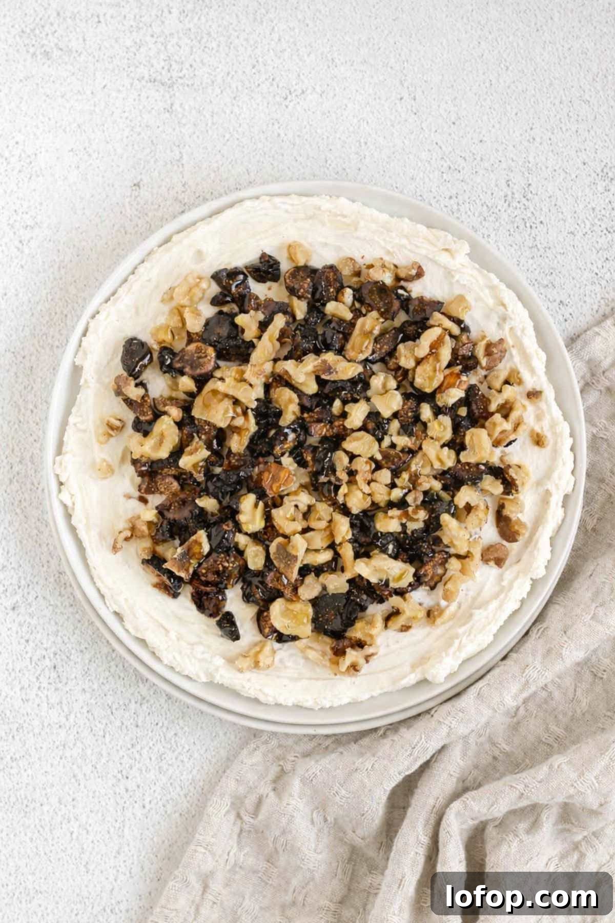Whipped Goat Cheese and Honey Dip — 5-Ingredient Recipe 6 Goat cheese spread on a round plate topped with sliced figs and chopped walnuts.