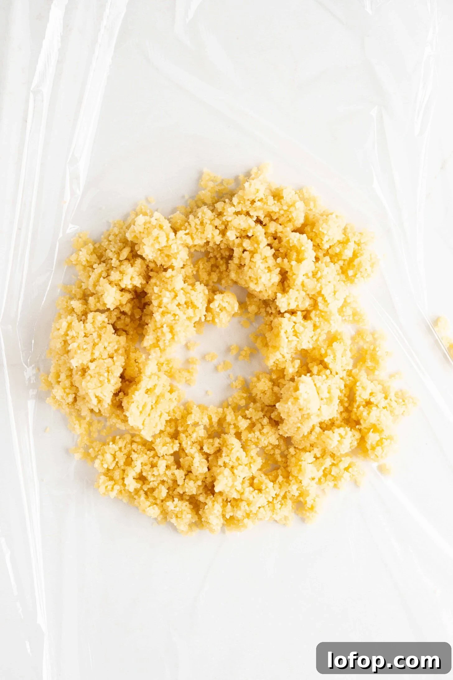 ground almond paste on plastic wrap