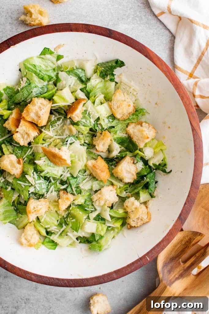 Top down view of a salad and croutons in a bowl.