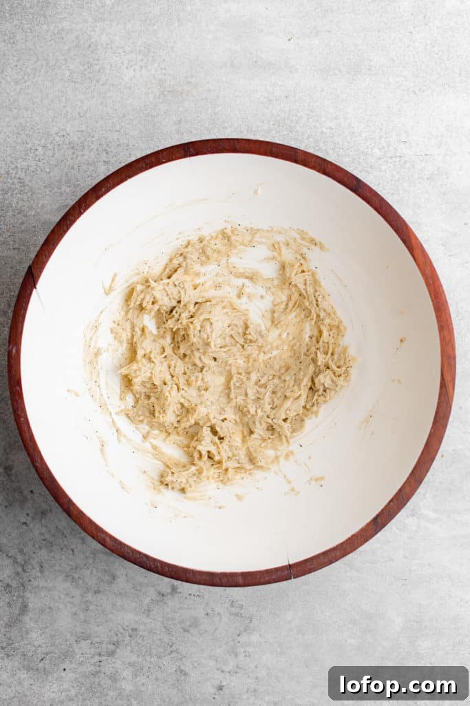 Top down view of Caesar dressing in a mixing bowl.