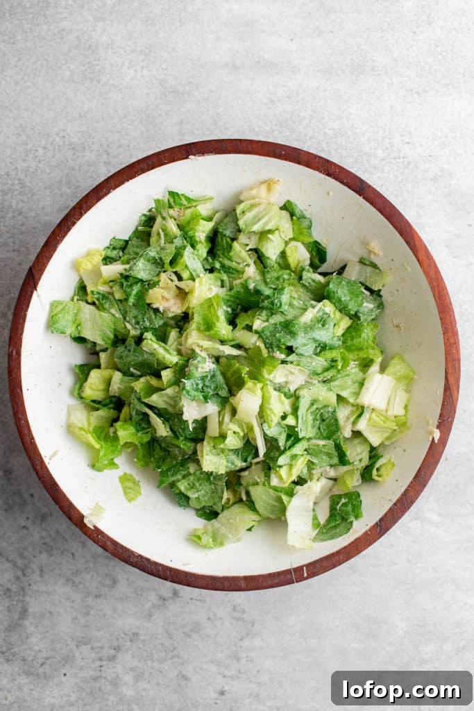 Top down view of salad in a mixing bowl.